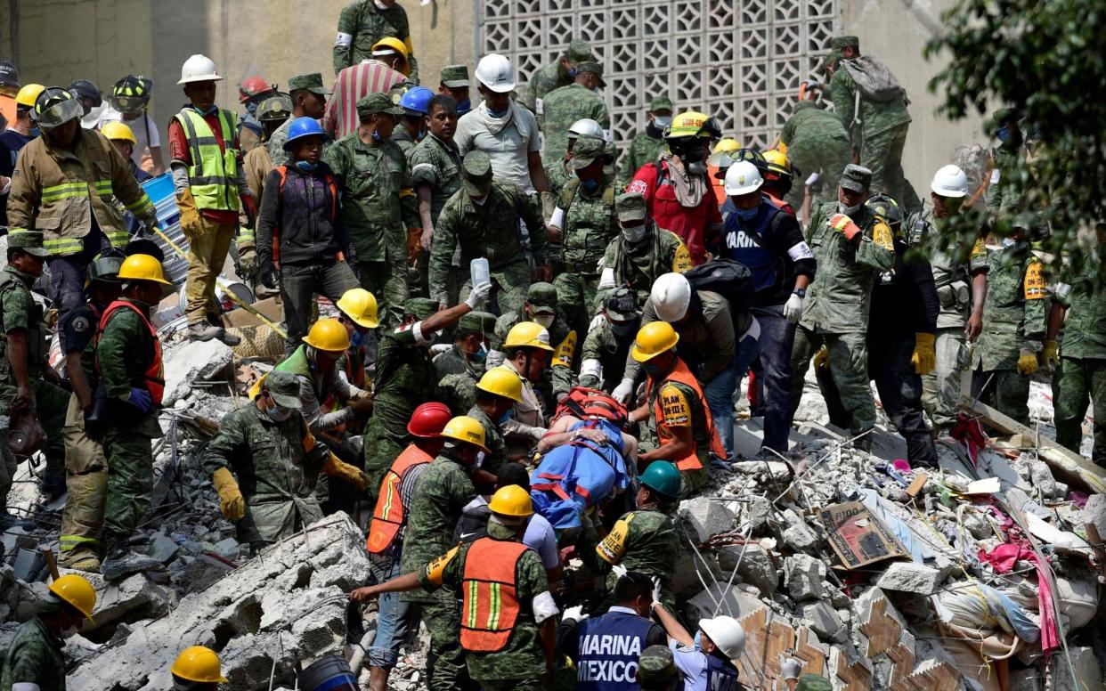 A man is pulled out of the rubble alive in Mexico City on September 20 - AFP