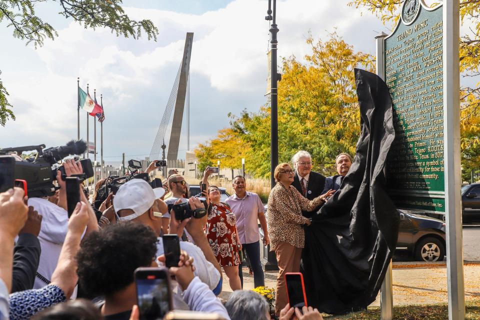 Sylvia Solis Saldivar, Michigan Music Hall of Fame President Kevin Hill and Frank Solis unveil the Michigan historical marker installed in honor of Detroit's Tejano music heritage in front of the Ford Resource and Engagement Center Sept. 29 in southwest Detroit.