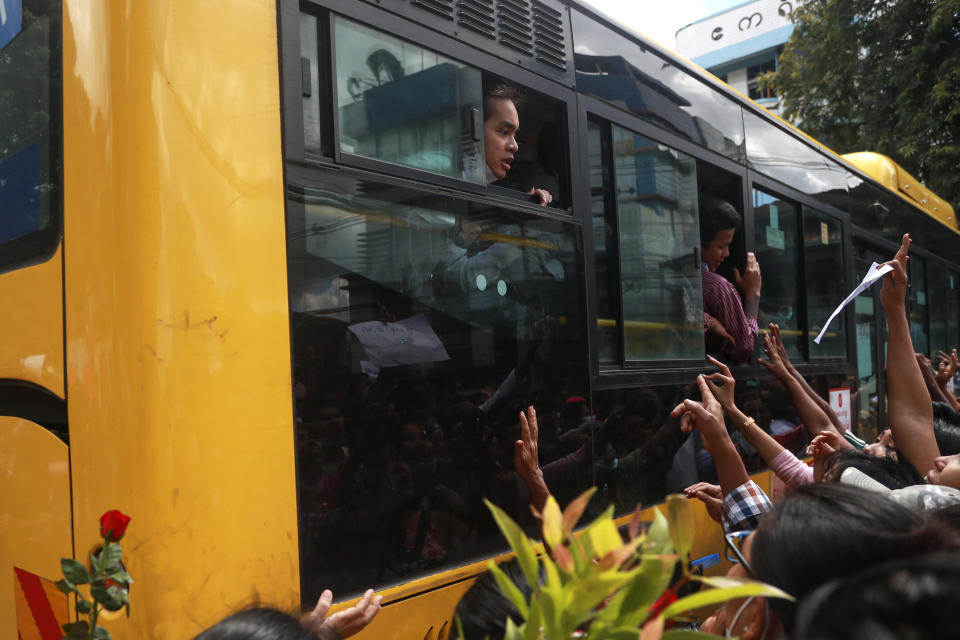 Detainees shout from a bus after a mass-prisoner release from the Insein Prison Tuesday, Oct. 19, 2021, in Yangon, Myanmar. Myanmar's government on Monday announced an amnesty for thousands of prisoners arrested for taking part in anti-government activities following February's seizure of power by the military. (AP Photo)