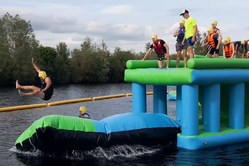 Visitors enjoying Southlake Waterpark in Little Paxton. The waterpark is on the freshwater lake and is perfect fun for the family