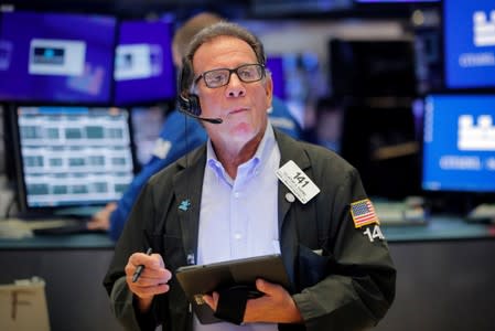 Traders work on the floor at the NYSE in New York