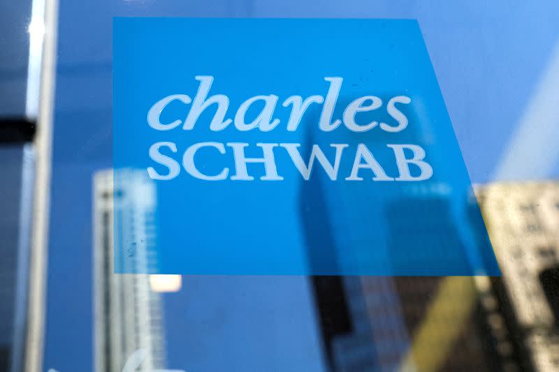 FILE PHOTO: The company logo for financial broker Charles Schwab is displayed at a location in the financial district in New York