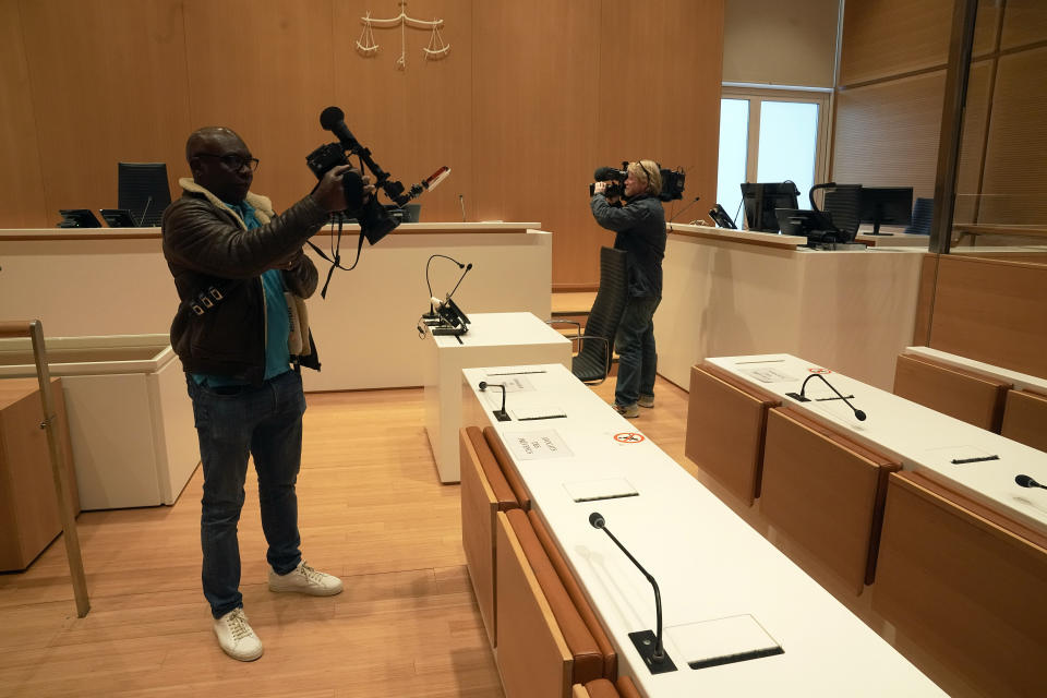 Journalists film the courtroom prior to the Rio Paris flight's trial, at the Paris courthouse, in Paris, Monday, Oct. 10 , 2022. Airbus and Air France go on trial on manslaughter charges Monday over the crash of a Rio-Paris flight in 2009 that plunged into the Atlantic amid thunderstorms. The accident kiled all 228 people aboard and led to changes in air safety regulations. (AP Photo/Michel Euler)