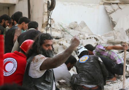 Rescuers and civilians search for survivors under the rubble of a damaged site hit by airstrikes in Idlib, Syria September 29, 2016. REUTERS/Ammar Abdullah