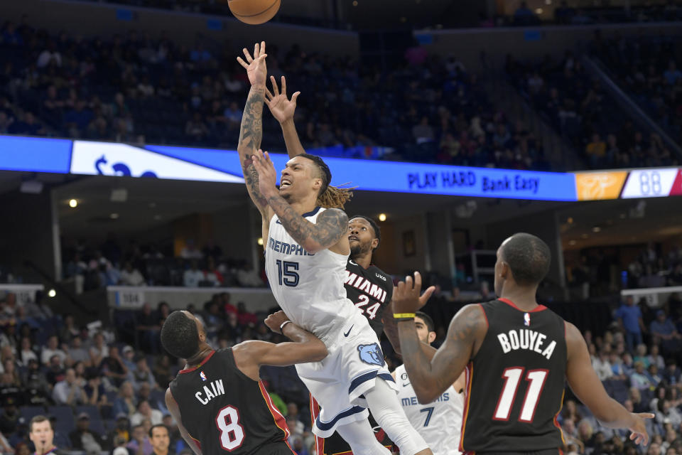 Memphis Grizzlies forward Brandon Clarke (15) jumps to shoot between Miami Heat forward Jamal Cain (8), forward Haywood Highsmith (24) and guard Jamaree Bouyea (11) in the second half of a preseason NBA basketball game Friday, Oct. 7, 2022, in Memphis, Tenn. (AP Photo/Brandon Dill)