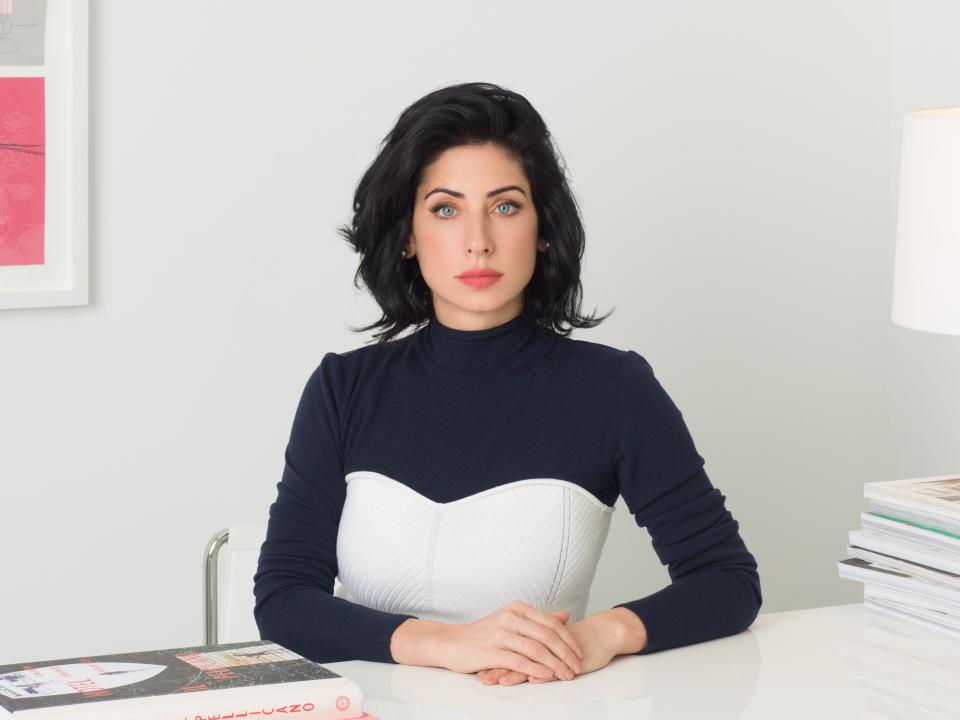 headshot of a woman in a white room with pink accents