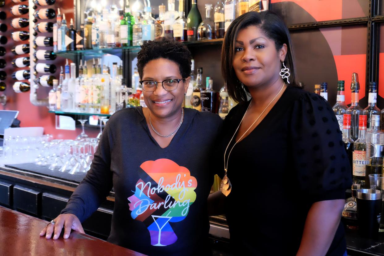 Angela Barnes, 54, (left) and Renauda Riddle, 42, (right) stand behind the bar of Nobody's Darling in Chicago, Illinois, on May 4, 2023.