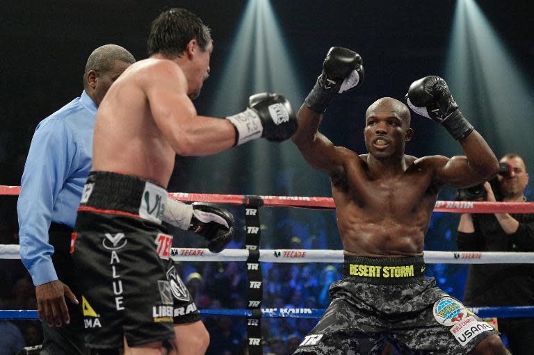 WBO welterweight champion Timothy Bradley (R) taunts Juan Manuel Marquez during their bout at the Thomas & Mack Center on October 12, 2013 in Las Vegas, Nevada