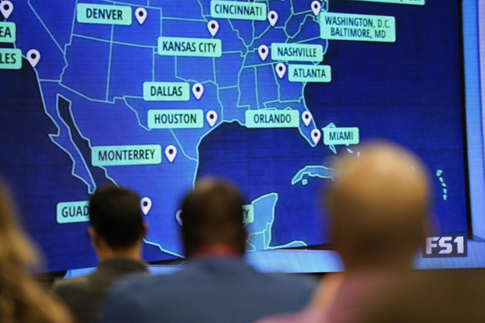 People wait and watch before FIFA announces the 2026 World Cup host cities, Thursday, June 16, 2022, in Atlanta. (AP Photo/Brynn Anderson)