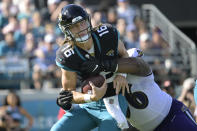 Baltimore Ravens defensive tackle Broderick Washington (96) sacks Jacksonville Jaguars quarterback Trevor Lawrence (16) during the first half of an NFL football game, Sunday, Nov. 27, 2022, in Jacksonville, Fla. (AP Photo/Phelan M. Ebenhack)