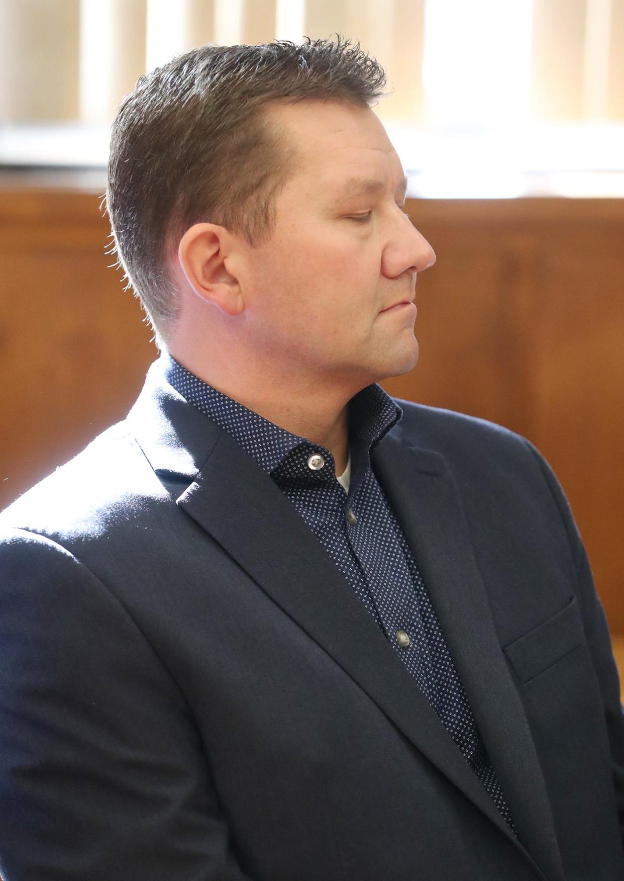 Former state Rep. Bob Young closes his eyes after Visiting Judge Edward O'Farrell found him guilty of domestic abuse in Young's bench trial in Barberton Municipal Court on Thursday. Young was found guilty of domestic violence and acquitted of assault.