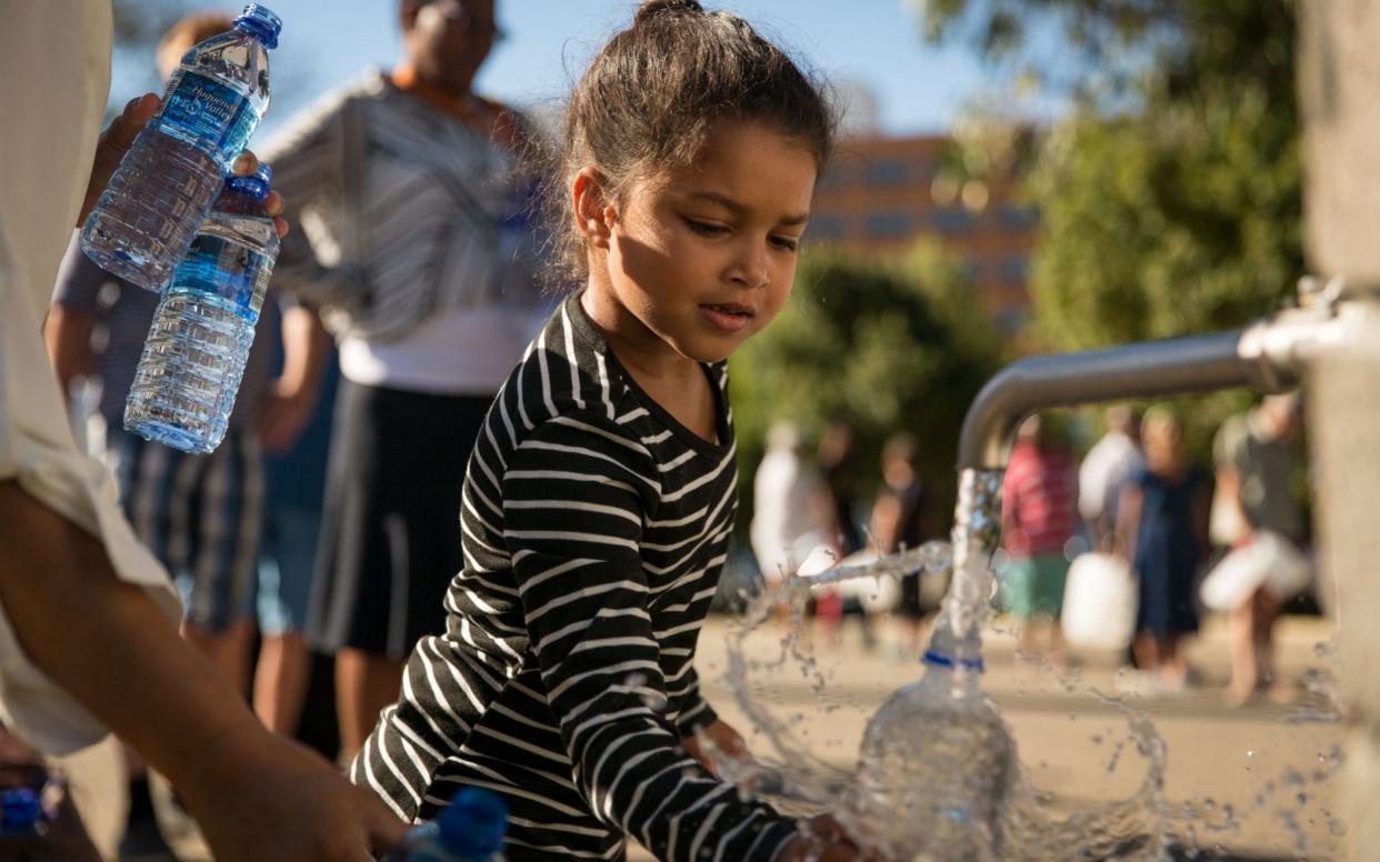People in Cape Town are forced to queue for water as a drought has led to the government warning that the city's taps may soon run dry - Dwayne Senior