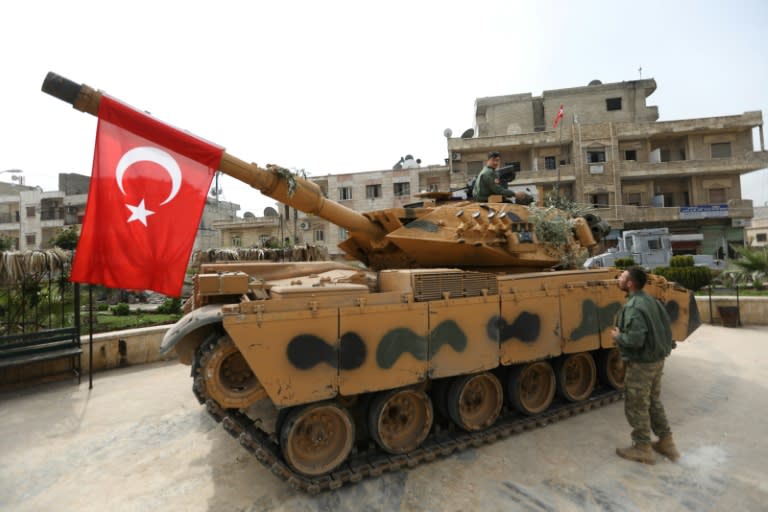 A tank belonging to Turkish soldiers and Ankara-backed Syrian Arab fighters is seen in the Kurdish-majority city of Afrin in northwestern Syria after they took control of it on March 18, 2018