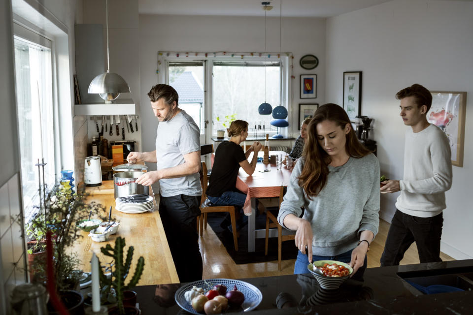 Family preparing food in kitchen