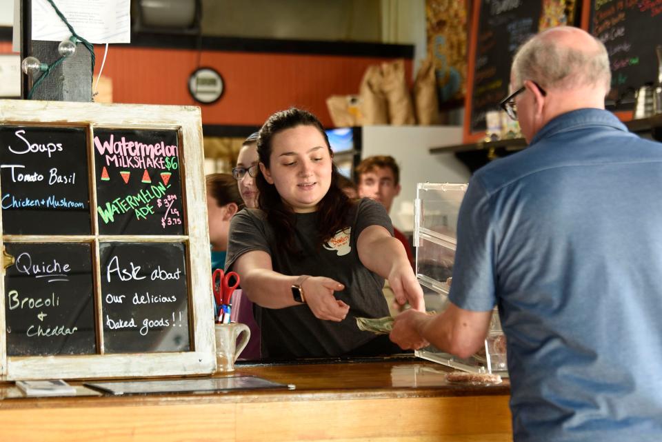 Madeline Mondloch, 21, waits on a customer at the Scullery Coffee House and Creamery in Greenville, N.C. On the day of a Trump campaign rally in Greenville where attendees chanted, 