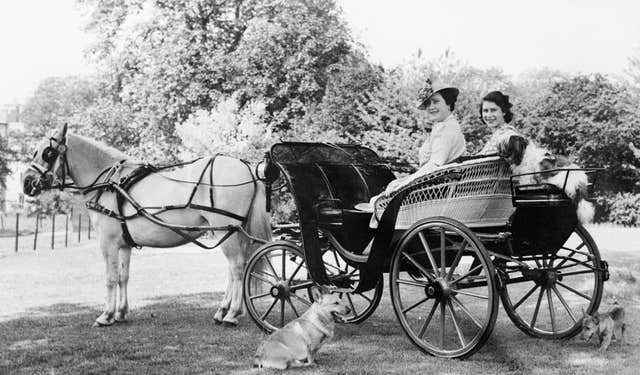 Princess Elizabeth and Queen Elizabeth, seated in a horse drawn carriage in the garden at Windsor Castle (Lisa Sheridan/PA)