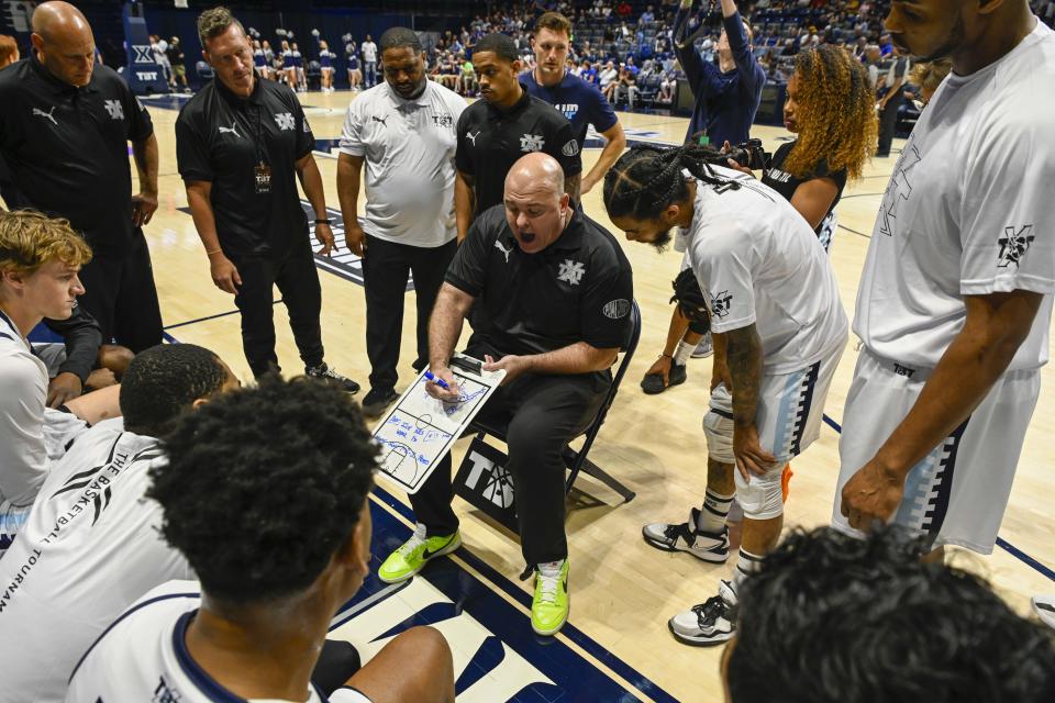 Zip'em Up coach Rick Carter talks to his team at The Basketball Tournament Friday, July 21, 2023, at the Cintas Center. The event featured Nasty 'Nati, which consisted of UC alumni, and Zip'em Up, made up of Xavier alumni.