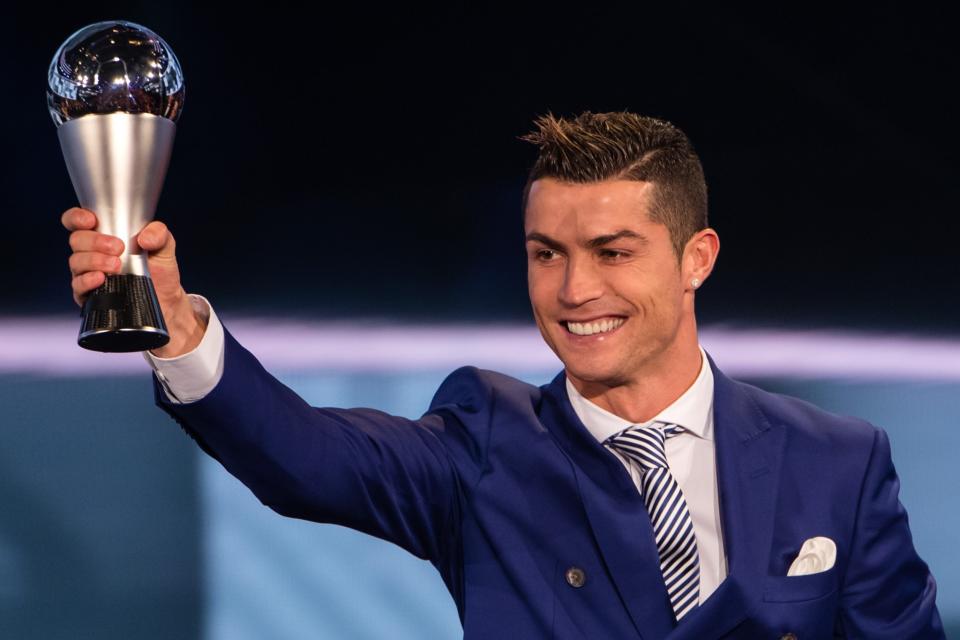 <p>FIFA player of the year Cristiano Ronaldo shows off his trophy </p>
