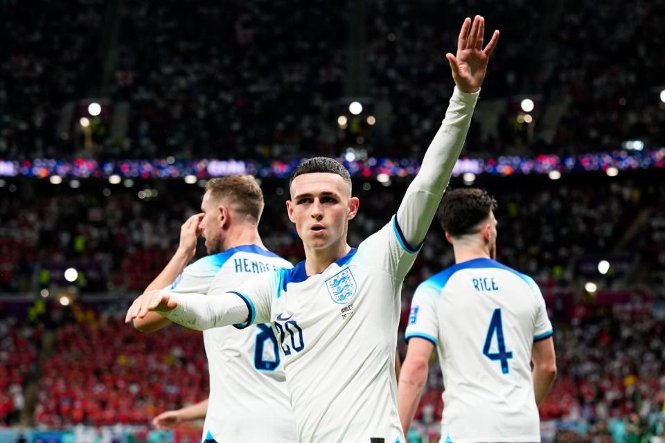 England's Phil Foden waves towards the fans after scoring his side's second goal during the World Cup group B football match between England and Wales, at the Ahmad Bin Ali Stadium in Al Rayyan, Qatar, Tuesday, Nov. 29, 2022. (AP Photo/Pavel Golovkin)