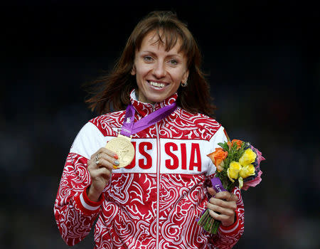 FILE PHOTO: Russia's Mariya Savinova holds her gold medal during the women's 800m victory ceremony at the London 2012 Olympic Games at the Olympic Stadium, Britain August 11, 2012. REUTERS/Eddie Keogh/File Photo