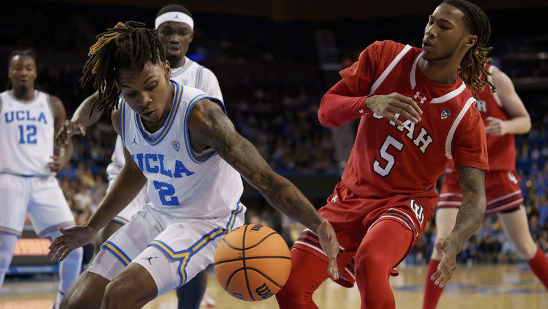 UCLA guard Dylan Andrews (2) and Utah guard Deivon Smith (5) go for a loose ball during the first half of an NCAA college basketball game, Sunday, Feb. 18, 2024, in Los Angeles. 