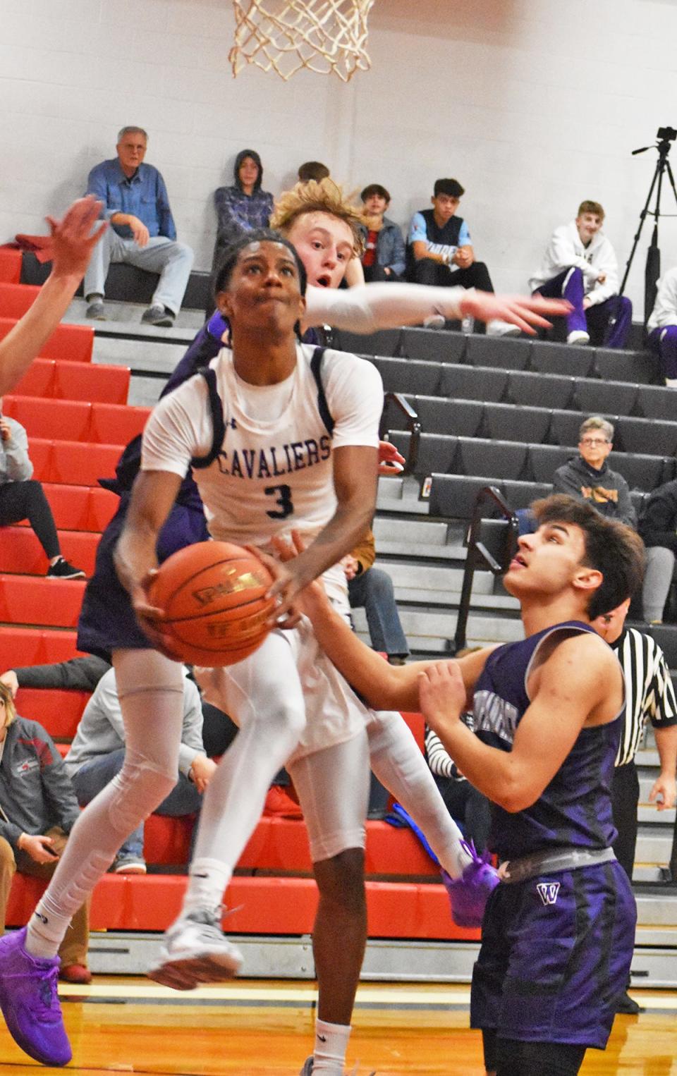 Logan Santos (3) of East Stroudsburg South slices through the Wallenpaupack Area defense on his way to an acrobatic basket. Santos was named to the All-Tournament Team by the Honesdale Area Jaycees Committee.