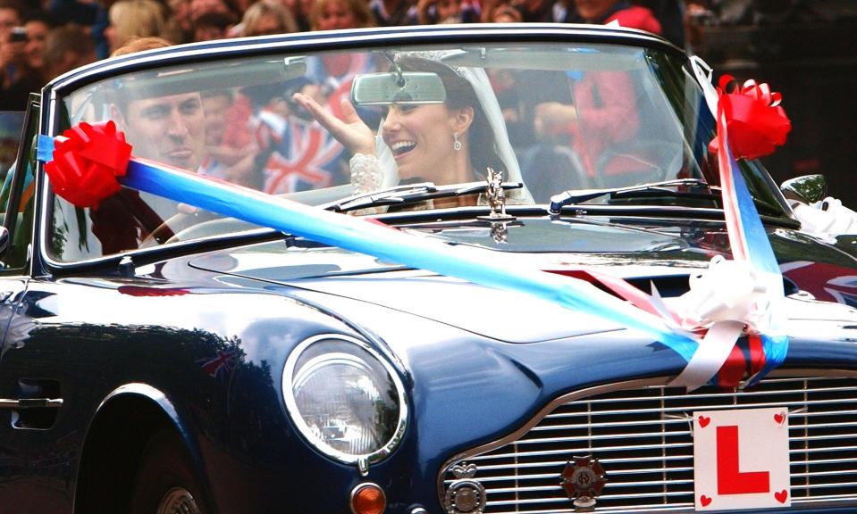 FILE - In this April 29, 2011, file photo taken by Max Nash, Britain's Prince William sticks his tongue out, as his wife Ket, Duchess of Cambridge, waves, as they drive from Buckingham Palace to Clarence House in a vintage Aston Martin Volante sports car, following their wedding at London's Westminster Cathedral. Nash, who covered the conflicts in Southeast Asia and the Middle East and helped nurture a new generation of female photojournalists during more than 40 years with The Associated Press, died Friday, Sept. 28, 2018, after collapsing at home. He was 77. (AP Photo/Max Nash, Pool, File)