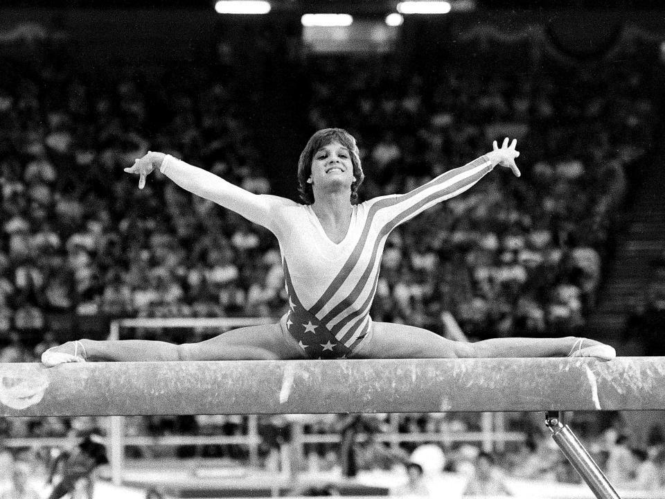 Mary Lou Retton does a split on a balance beam at the Olympics