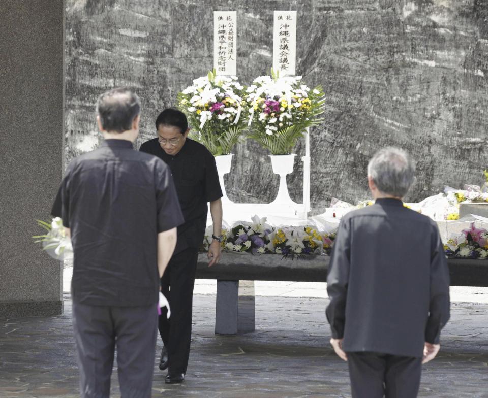 Japan's Prime Minister Fumio Kishida, rear, walks after laying flowers at the cemetery for the war dead at the Peace Memorial Park in Itoman, Okinawa prefecture, southern Japan Friday, June 23, 2023. Japan marked the Battle of Okinawa, one of the bloodiest battles of World War II fought on the southern Japanese island, which ended 78 years ago. (Kyodo News via AP)