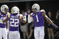 LSU wide receiver Ja'Marr Chase (1) celebrates with running back Clyde Edwards-Helaire (22) after Chase scored a touchdown on a 51-yard pass play against Vanderbilt in the first half of an NCAA college football game Saturday, Sept. 21, 2019, in Nashville, Tenn. (AP Photo/Mark Humphrey)