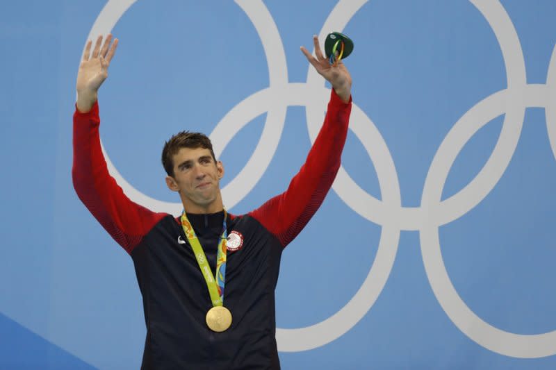 Michael Phelps of the United States stands with his gold medal after taking first place in the men's 200m individual medley with a time of 1:54.66 at the Olympic Aquatics Stadium at the 2016 Rio Summer Olympics in Rio de Janeiro, Brazil, on August 11, 2016. File Photo by Matthew Healey/UPI