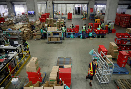 Employees work at RedMart's fulfillment centre in Singapore September 22, 2017. REUTERS/Edgar Su