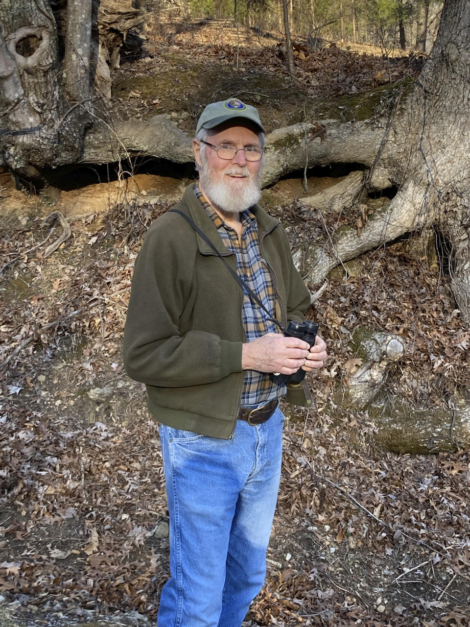 This image provided by Steve Kistler shows Kistler looking for birds on Feb. 13, 2023, near his home in Hart County, Kentucky. He has participated every year in the Great Backyard Bird Count, a citizen science project that collects data used by researchers to track bird populations. (Steve Kistler/Janet Kistler via AP)