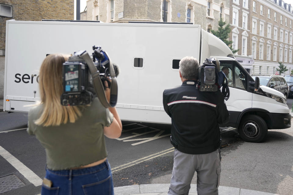 Journalists film a prison van moving into Westminster Magistrates Court in London, Wednesday, Aug. 17, 2022. A 20-year-old man has been charged with intending to injure or alarm The Queen under the Treason Act following an incident on Christmas Day 2021 at Windsor Castle. Jaswant Singh Chail was charged with an offence under section two of the Treason Act 1842 - last used more than 40 years ago - which is 'discharging or aiming firearms, or throwing or using any offensive matter or weapon, with intent to injure or alarm Her Majesty'. (AP Photo/Frank Augstein)