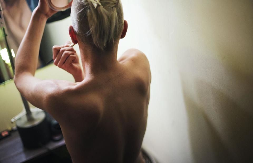 In this photo taken Saturday, Feb. 8, 2014, Lisa, who would only give his stage name, gets ready backstage before a performance at the Mayak cabaret, the most reputable gay club in Sochi, Russia, host to 2014 Winter Olympics. Russia adopted a law last year, prohibiting vaguely defined propaganda of non-traditional sexual relations and pedophilia. The legislation makes it illegal to disseminate information to children even if it merely shows that gay people are just like everybody else. At Mayak, packed on Saturday night, gay men and women steered away from discussing the law, preferring to enjoy life, closeted as it is. About a hundred people were chatting at the bar, sitting in armchairs or dancing. Couples were sharing kisses. Everyone was waiting for the club's specialty: a drag show. At 1.30 a.m. on Sunday, the music stopped and the show began. (AP Photo/David Goldman)