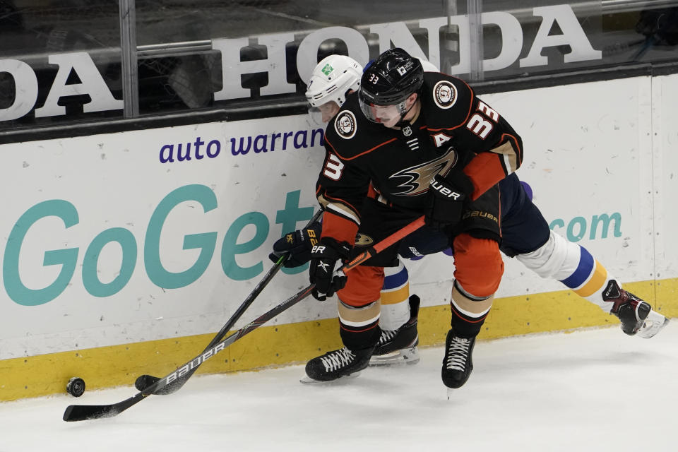 Anaheim Ducks' Jakob Silfverberg (33), of Sweden, fights for the puck with St. Louis Blues' Jaden Schwartz during the second period of an NHL hockey game Saturday, Jan. 30, 2021, in Anaheim, Calif. (AP Photo/Jae C. Hong)