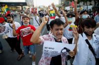 Myanmar citizens shout as they join with Thai protesters an anti-government protest in Bangkok