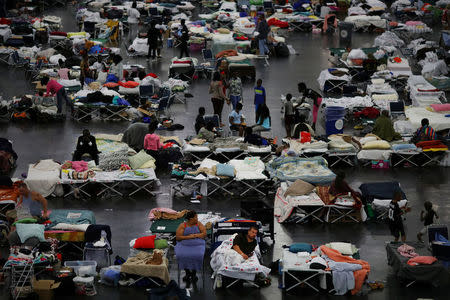 Evacuees affected by Tropical Storm Harvey take shelter at the George R. Brown Convention Center in downtown Houston, Texas, U.S. August 31, 2017. REUTERS/Carlos Barria