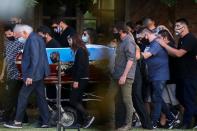 Friends and family carry the casket of soccer legend Diego Armando Maradona, at the cemetery in Buenos Aires
