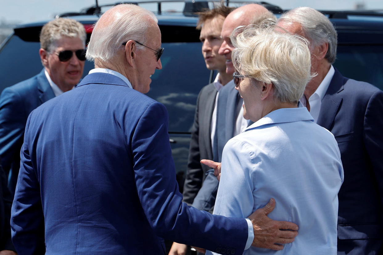 U.S. President Joe Biden interacts with U.S. Senator Elizabeth Warren (D-MA) and other elected officials after arriving at T.F. Green International Airport in Warwick, Rhode Island, U.S. July 20, 2022. Picture taken July 20, 2022. REUTERS/Jonathan Ernst