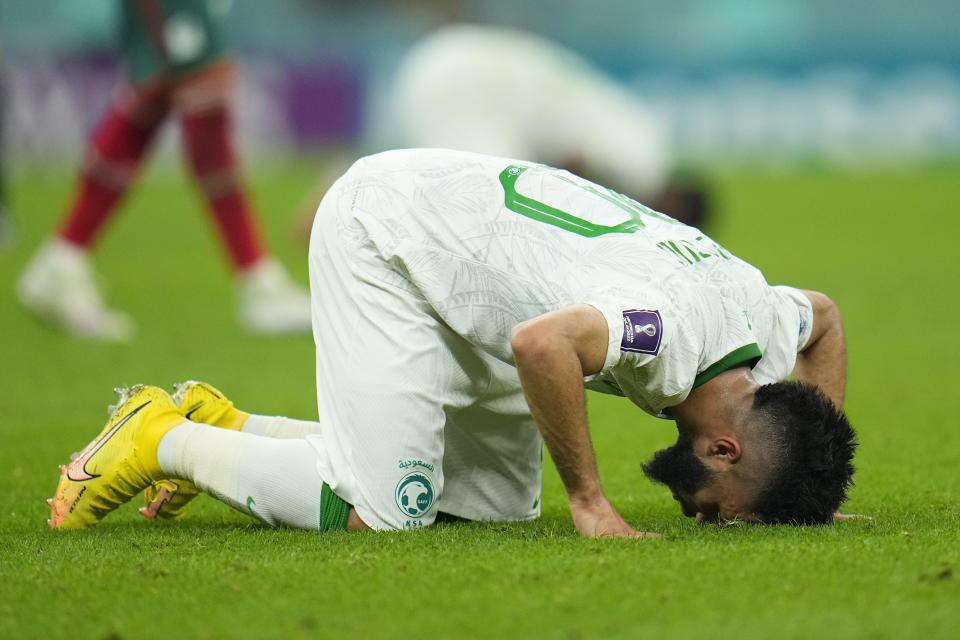 Saudi Arabia's Abdulrahman Al-Aboud kneels after losing 2-1 in the World Cup group C soccer match between Saudi Arabia and Mexico, at the Lusail Stadium in Lusail, Qatar, Wednesday, Nov. 30, 2022. (AP Photo/Julio Cortez)