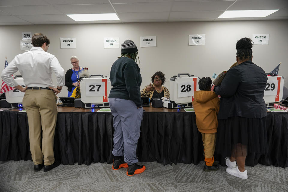 Voters receive their ballots during early in-person voting at the Hamilton County Board of Elections in Cincinnati, Wednesday, Oct. 11, 2023. (AP Photo/Carolyn Kaster)