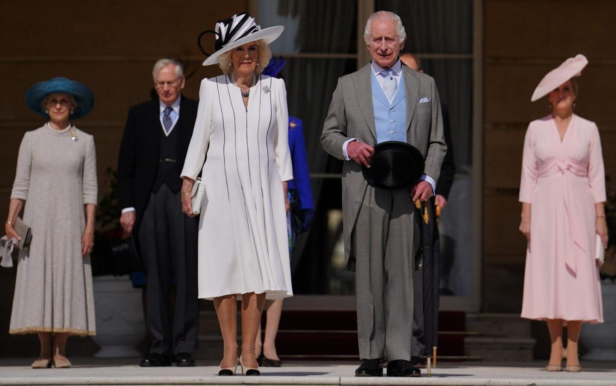 King Charles and Queen Camilla stand with the Duke and Duchess of Edinburgh and the Duke and Duchess of Gloucester as they listen to the national anthem