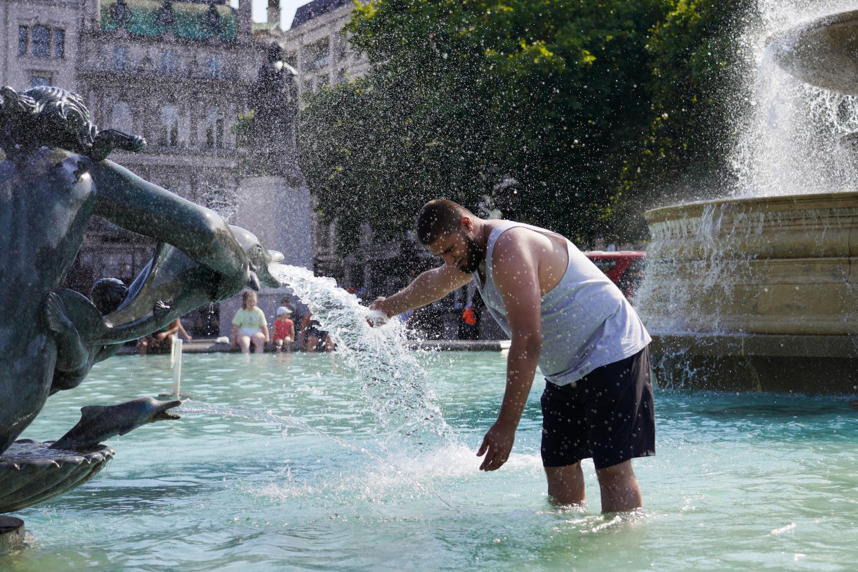 keep cool A man enjoys the cool water in the fountains in Trafalgar Square during record breaking heat on the 19th of July 2022, Central London, United Kingdom. Climate change brought on by fossil fuel emmissions is causing havoc across the UK and Europe with searing temperatures.  (photo by Kristian Buus/In Pictures via Getty Images)