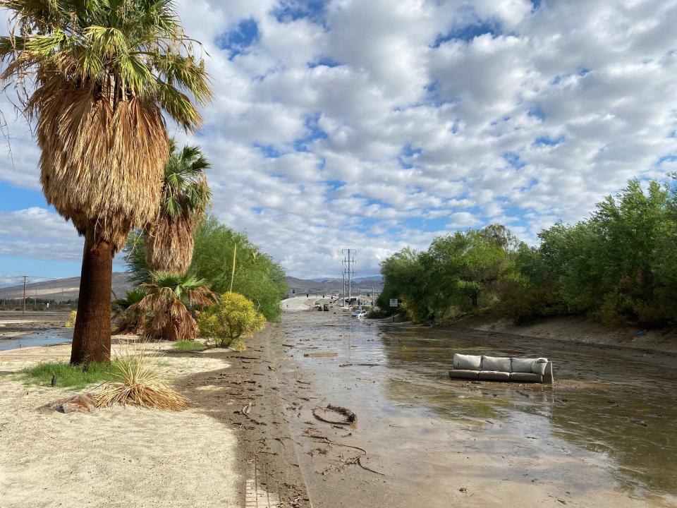 A couch floats down Bob Hope Drive in Rancho Mirage, California, on Monday after Tropical Storm Hilary inundated the area.