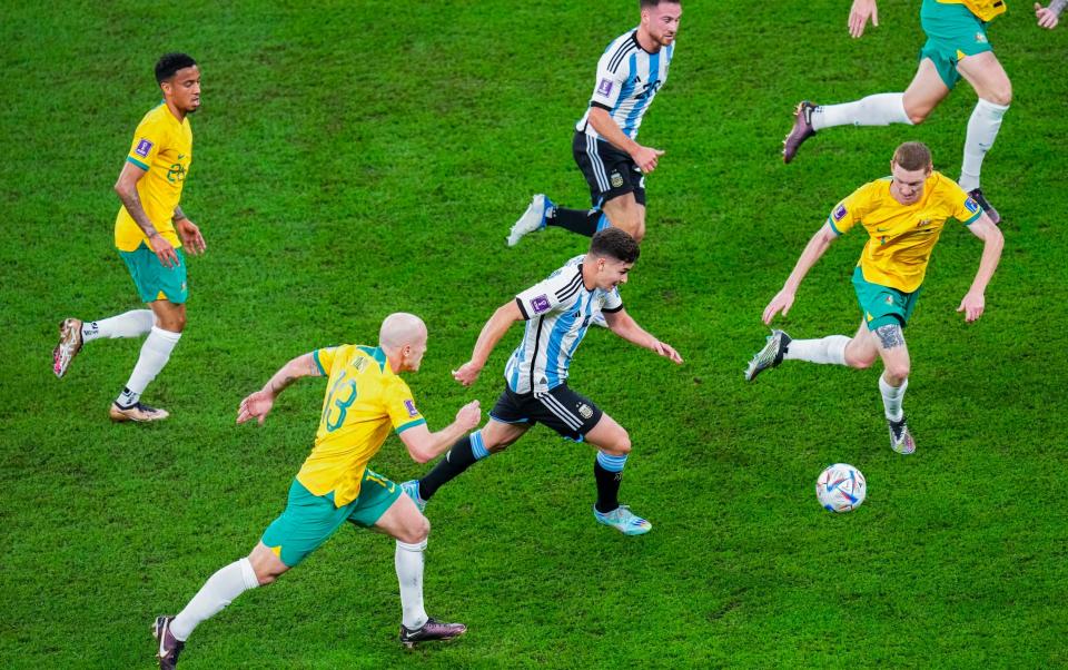 Argentina's Julian Alvarez, center, vies for the ball with Australia defenders during the World Cup round of 16 soccer match between Argentina and Australia at the Ahmad Bin Ali Stadium in Doha - AP