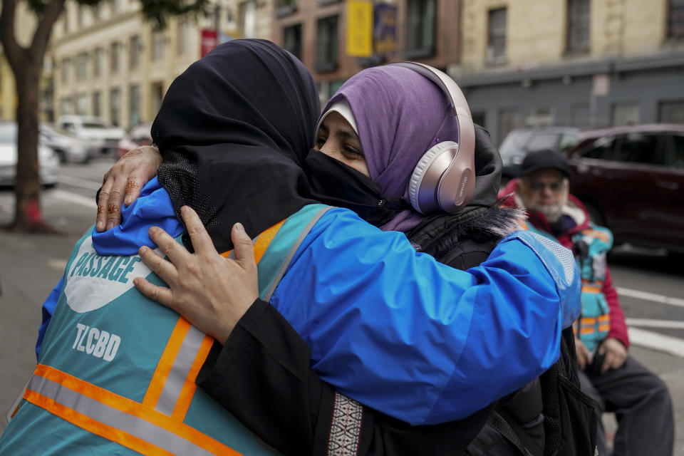 Tatiana Alabsi, left, is hugged by her sister-in-law Bushra Tanaka Alabsi while working in the Tenderloin neighborhood Wednesday, March 27, 2024, in San Francisco. (AP Photo/Godofredo A. Vásquez)