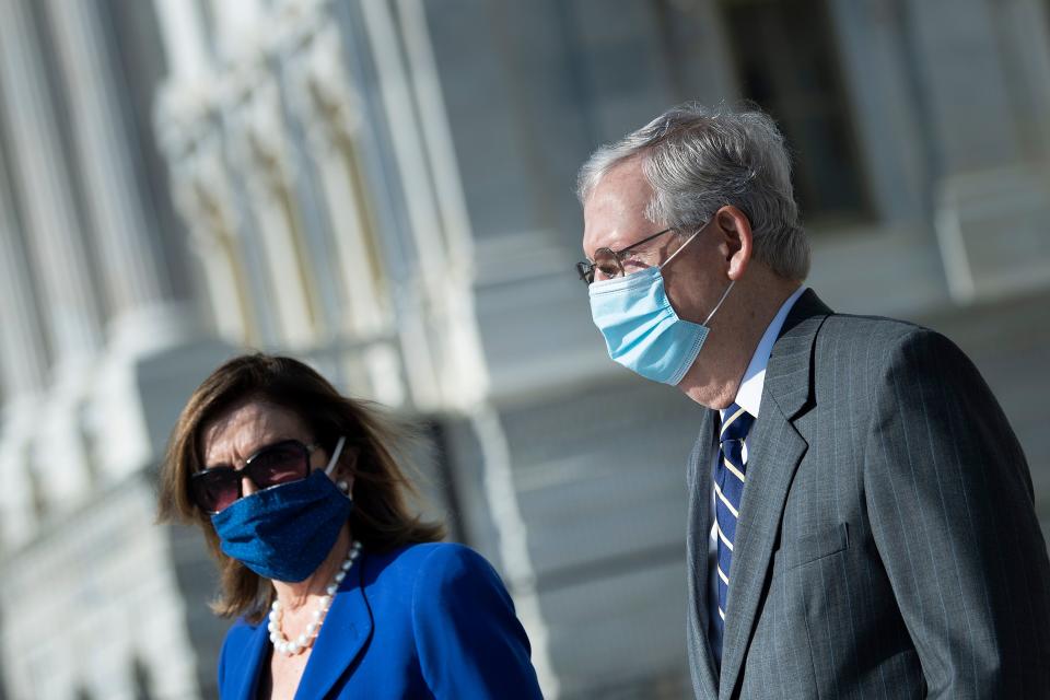 Speaker of the House Nancy Pelosi (D-CA) and Senate Majority Leader Senator Mitch McConnell (R-KY) arrive to watch as the casket with the remains of Rep. John Lewis (D-GA) is carried from the US Capitol building July 29, 2020, in Washington, DC. (Photo by Brendan Smialowski / POOL / AFP) (Photo by BRENDAN SMIALOWSKI/POOL/AFP via Getty Images)