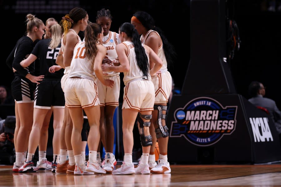 Texas players, right, and Gonzaga players huddle during the first half of a Sweet 16 college basketball game in the women’s NCAA Tournament, Friday, March 29, 2024, in Portland, Ore. (AP Photo/Howard Lao)