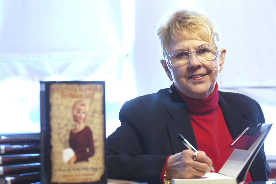 FILE - In this Jan. 11, 2008, file photo, Peggy Sue Gerron unveils her new book "What Ever Happened to Peggy Sue" during a press conference in Tyler, Texas. Gerron, the Texas woman who inspired the 1958 Buddy Holly song "Peggy Sue" has died at a Lubbock hospital. Gerron Rackham of Lubbock died Monday, Oct. 1, 2018, at University Medical Center. She was 78. (Jaime R. Carrero/Tyler Morning Telegraph, via AP, File)